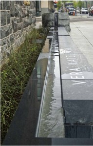 Vera Katz Park. The old armory building as at left, the sidewalk is at right, the park -- black marble, with water trickling down the middle --  is in the middle.